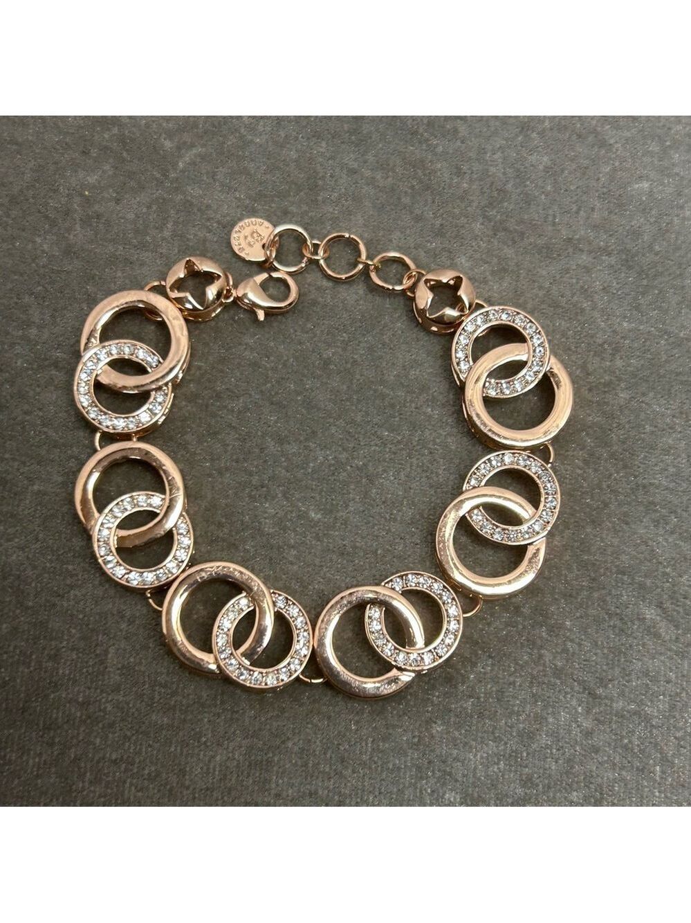 Absolute rose gold tone circular interlocking chain-link rhinestone bracelet